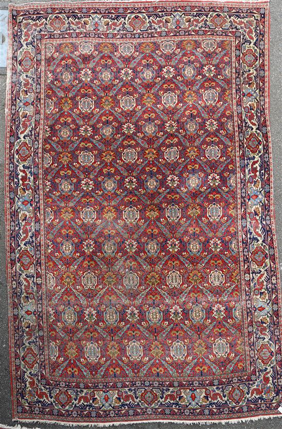A Persian red ground carpet, 11ft x 7ft 11in.